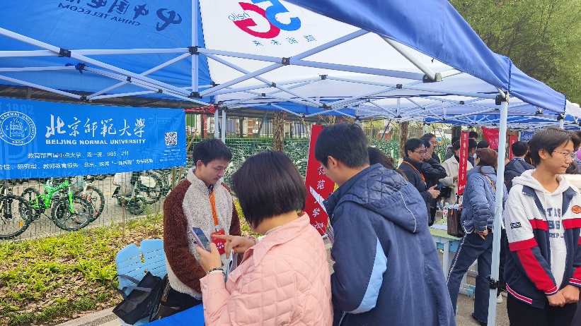 A group of people standing under a tent Description automatically generated